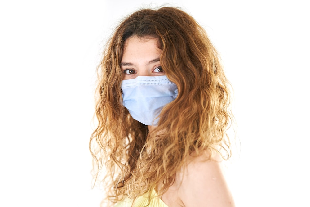 woman in white tank top with white face mask