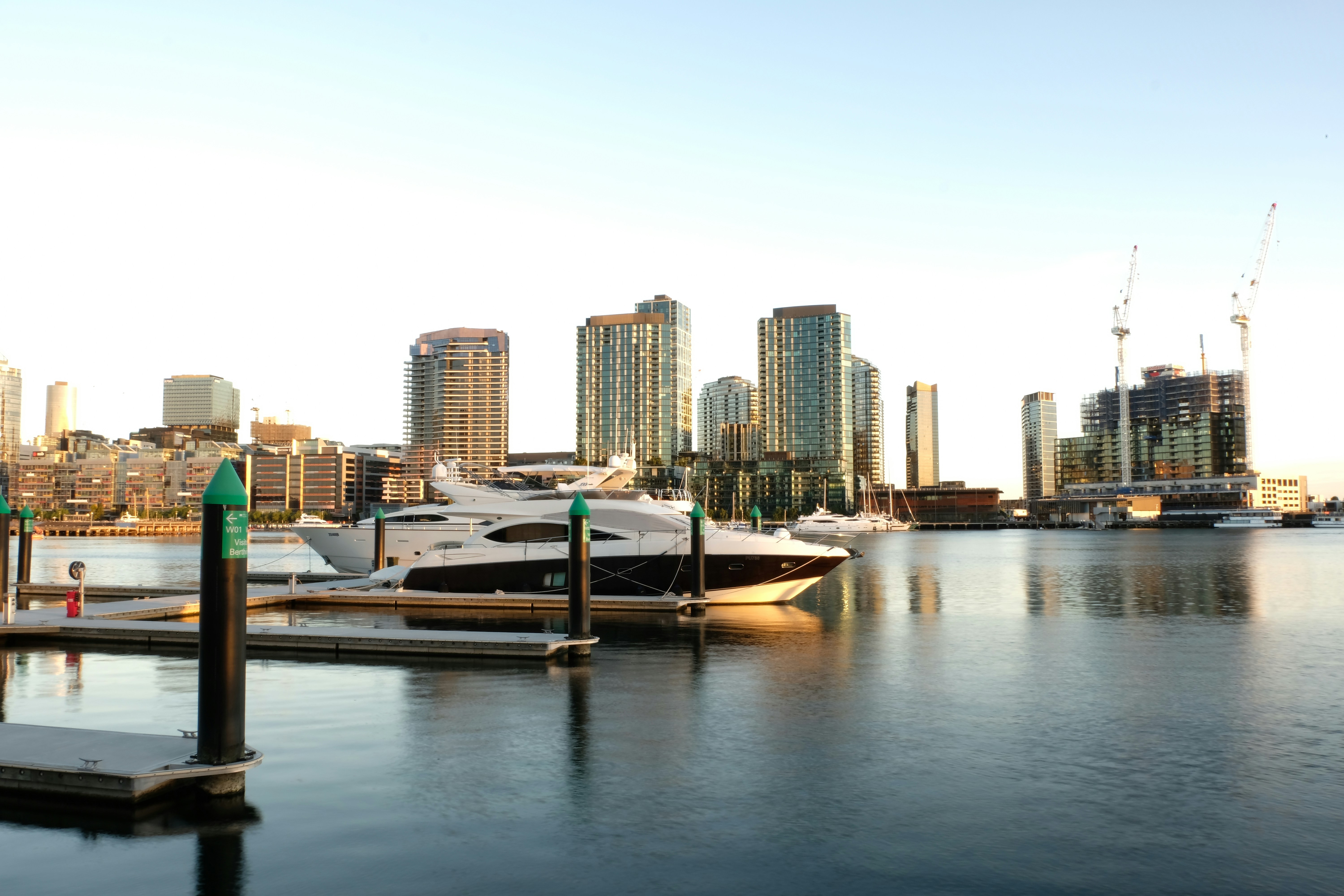 white and brown boat on water near city buildings during daytime