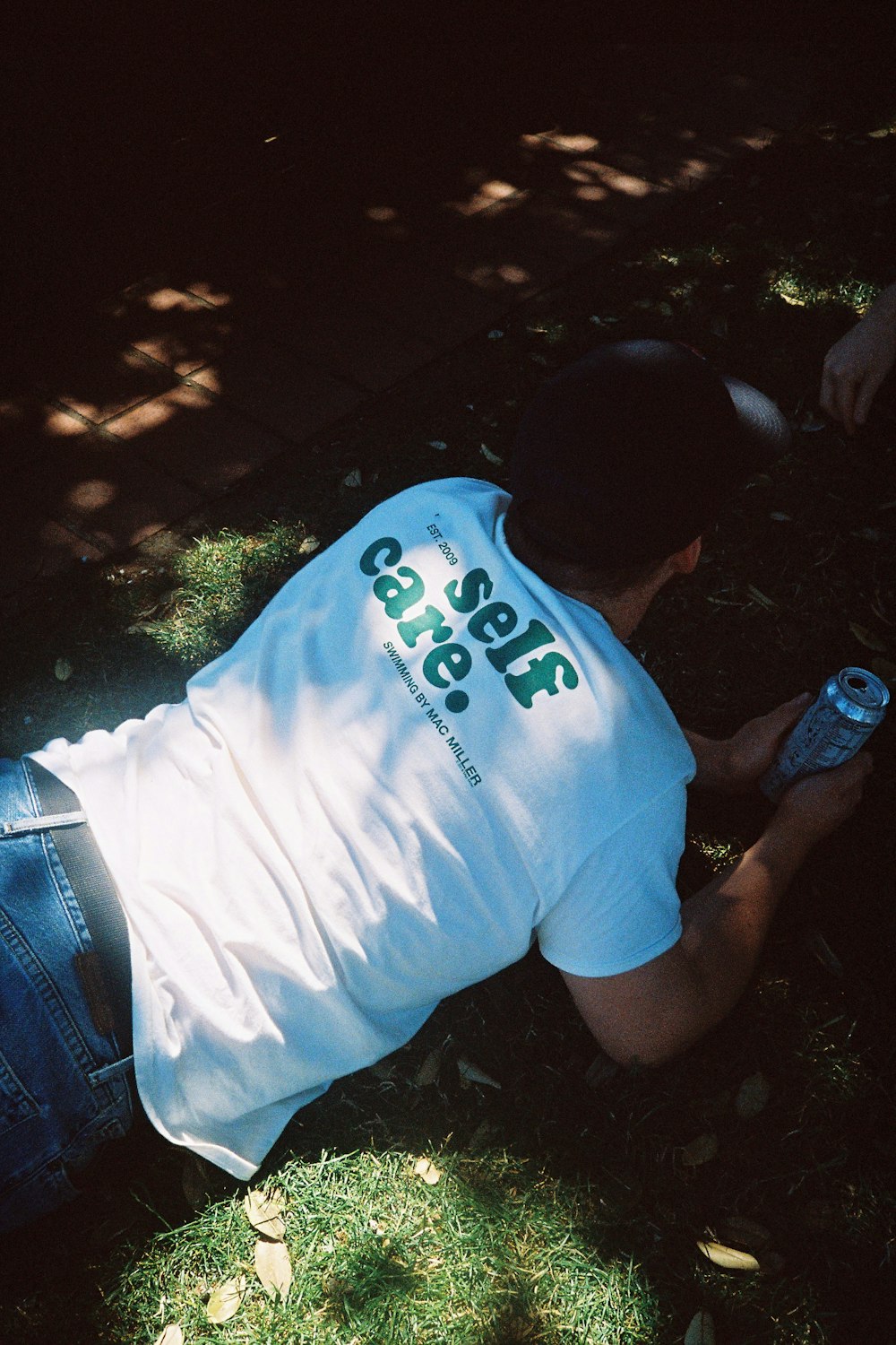 man in white t-shirt and blue denim shorts