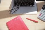 A professional workspace featuring accounting tools and a laptop.
