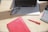 A close-up of a Canadian work visa on a wooden desk next to a laptop and notes.