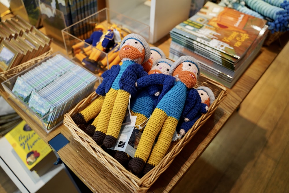 assorted knitted toys on brown wooden shelf