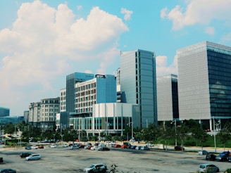 cars parked near high rise building during daytime