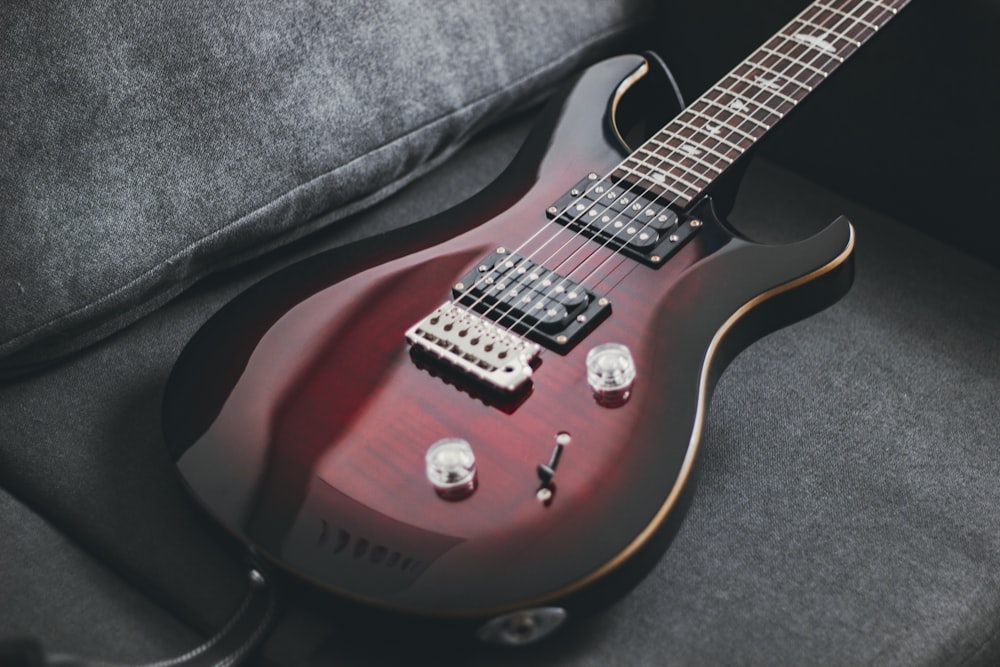 red and black electric guitar