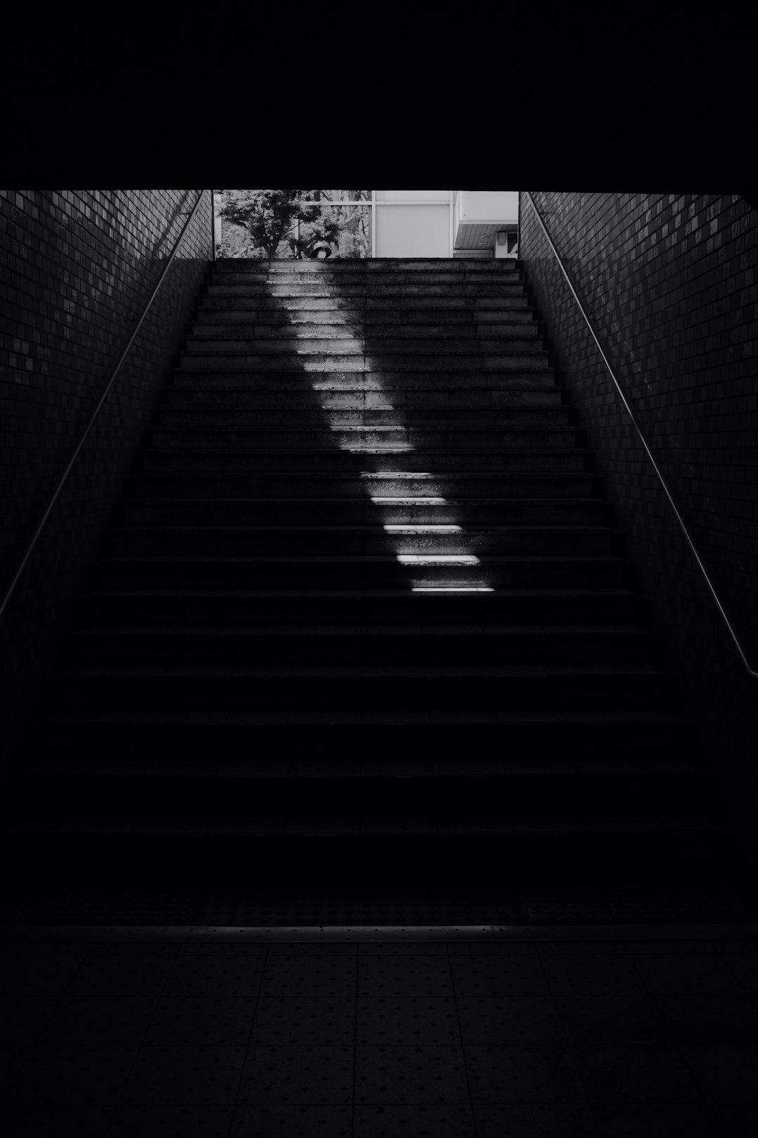 grayscale photo of a tunnel