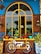 A colorful outdoor scene with a decorative bicycle frame design attached to a brick wall. The window above the bike has a bright yellow arch and is surrounded by various potted plants. The background features a wooden and blue facade, with ornate patterns on the side ceramic planters.