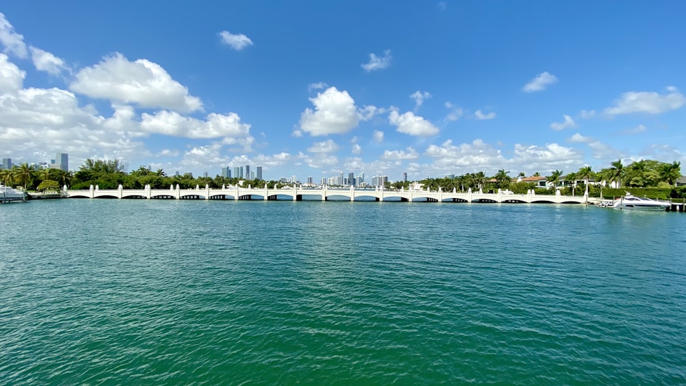 white wooden dock on sea under blue sky during daytime