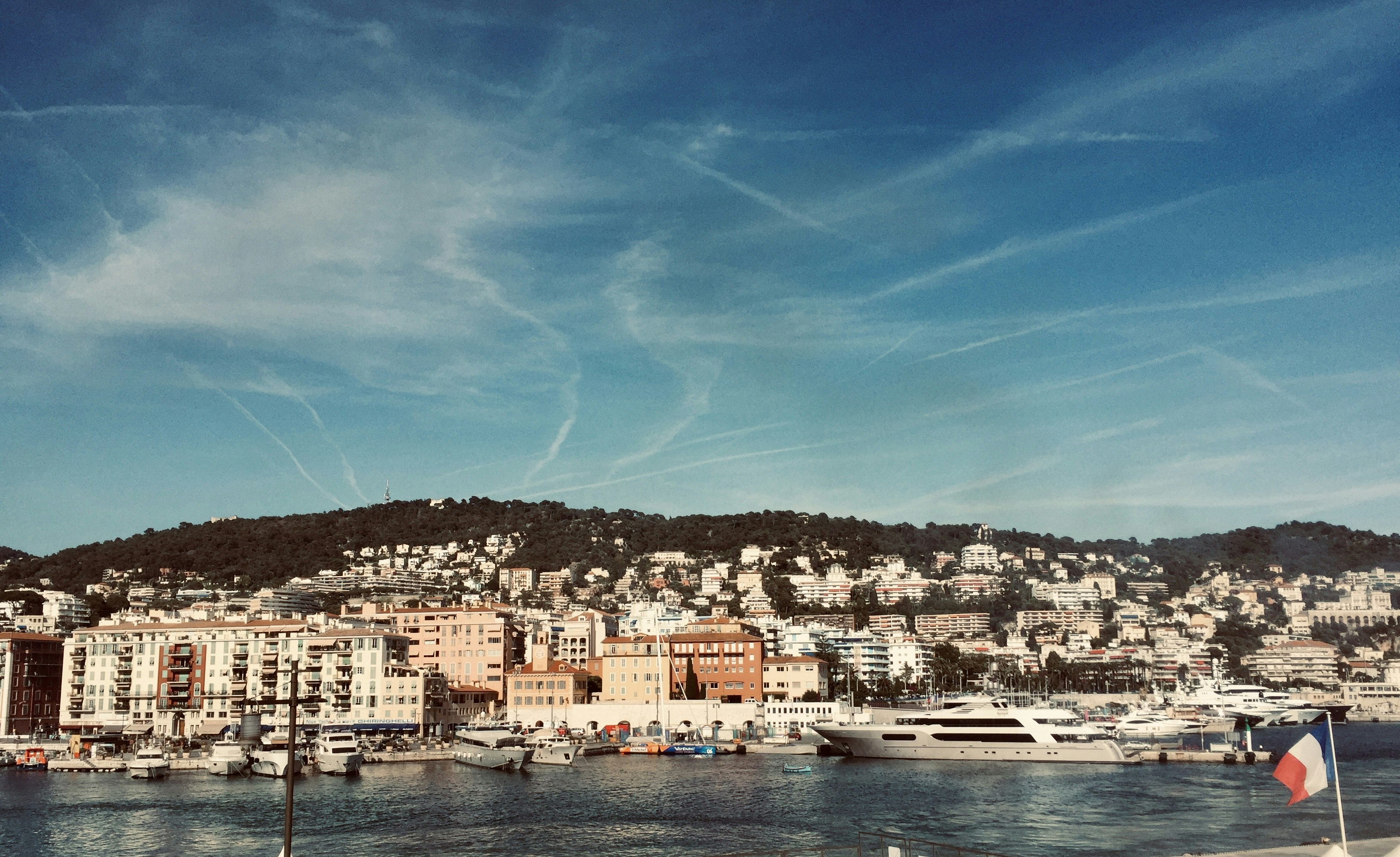 city buildings near body of water under blue sky during daytime