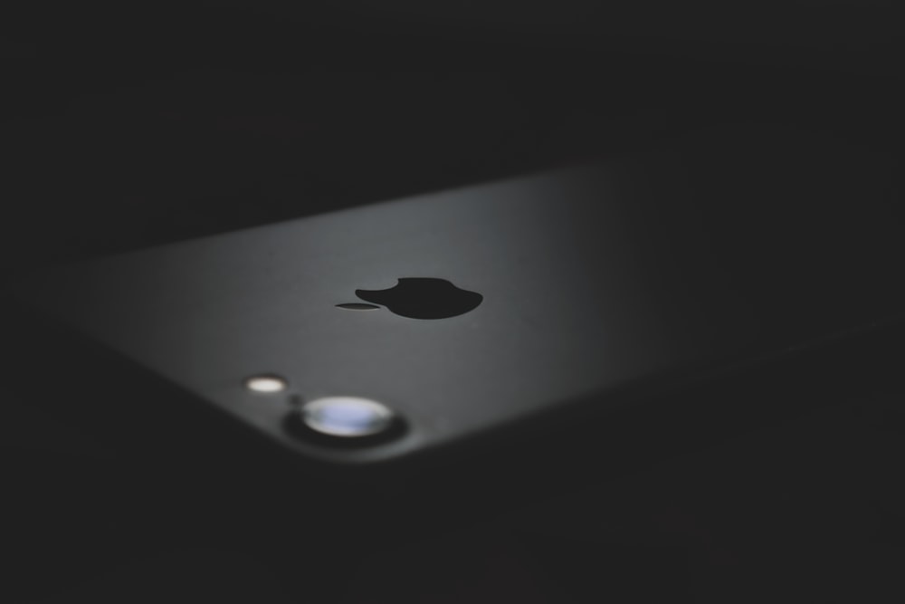 silver iphone 6s on black surface