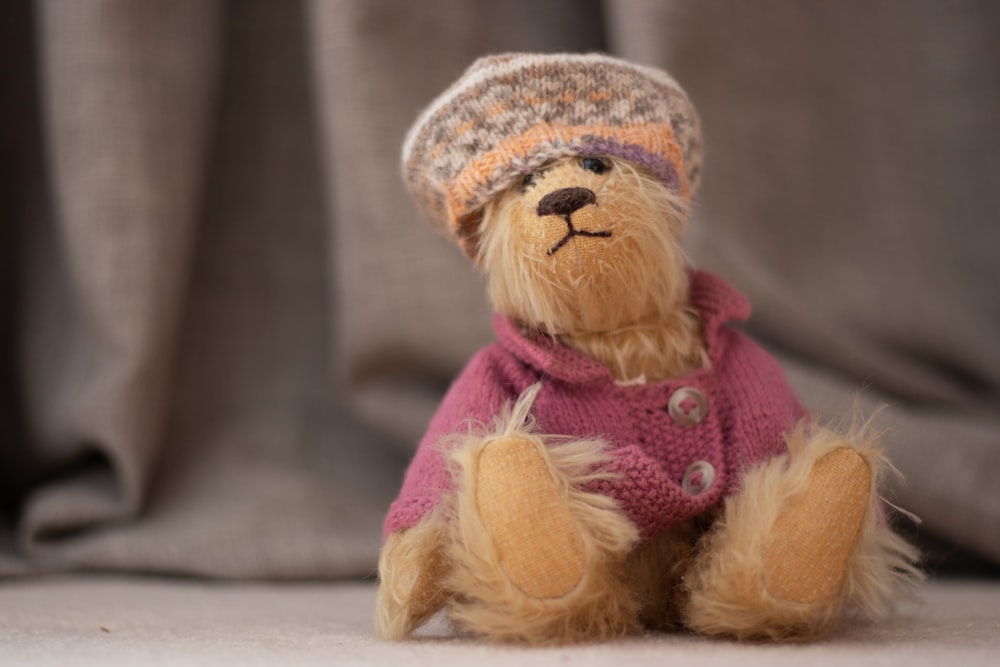 brown bear plush toy on brown wooden table