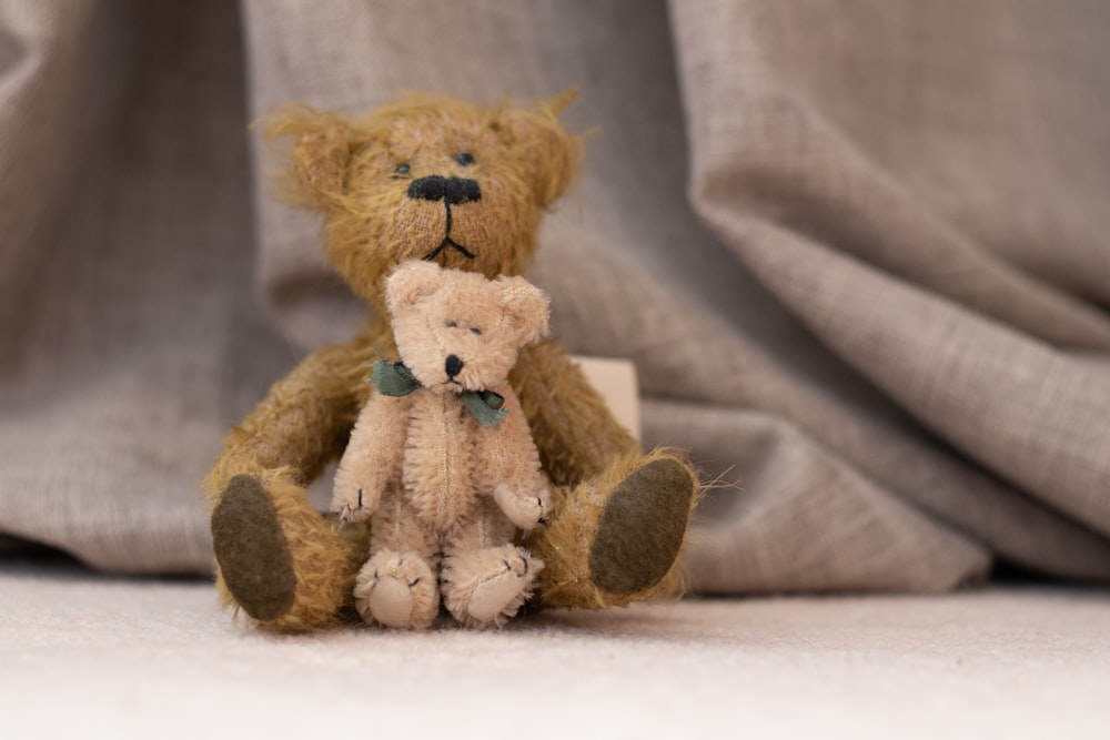 brown teddy bear on brown textile
