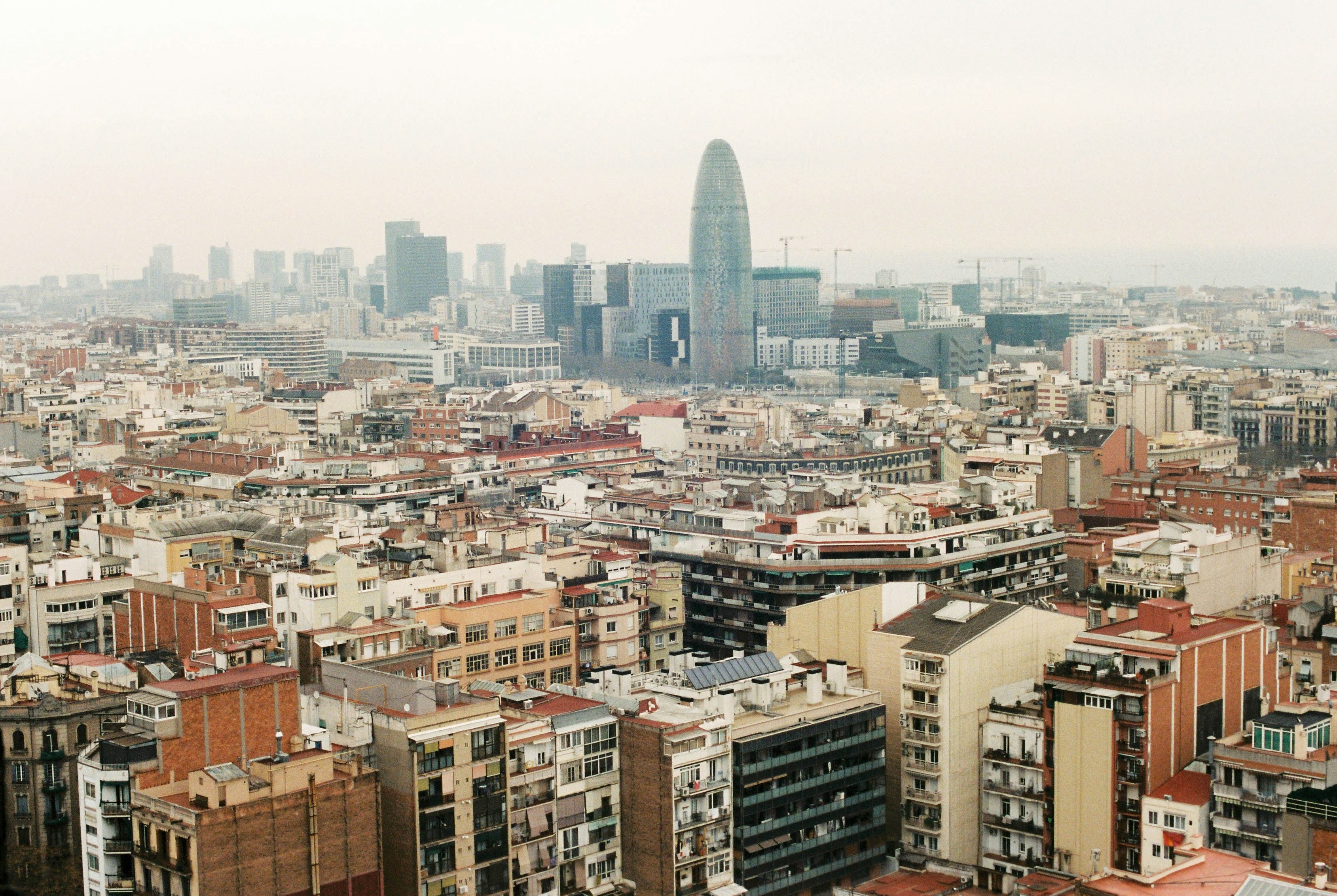 aerial view of city buildings during daytime, Barcelona Skyline from Sagrada Familia.