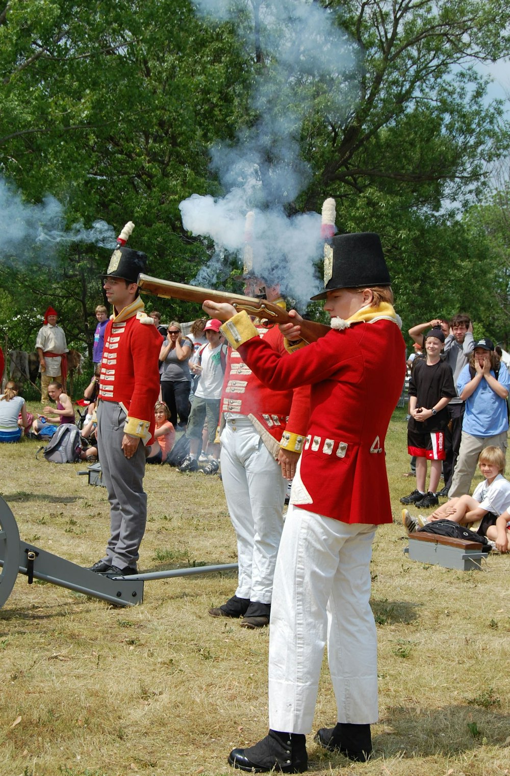 man in red shirt holding rifle