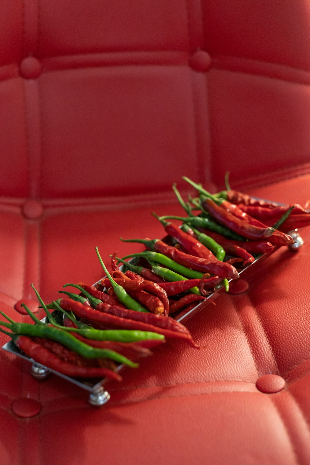 green chili on red leather textile