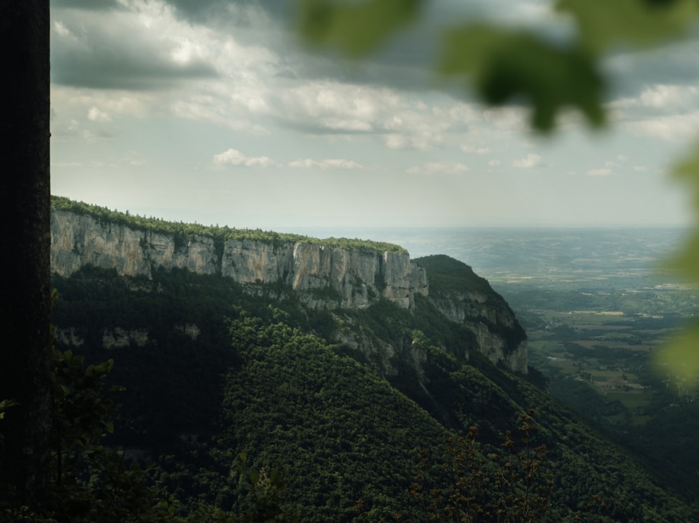 green and gray mountain under white clouds during daytime