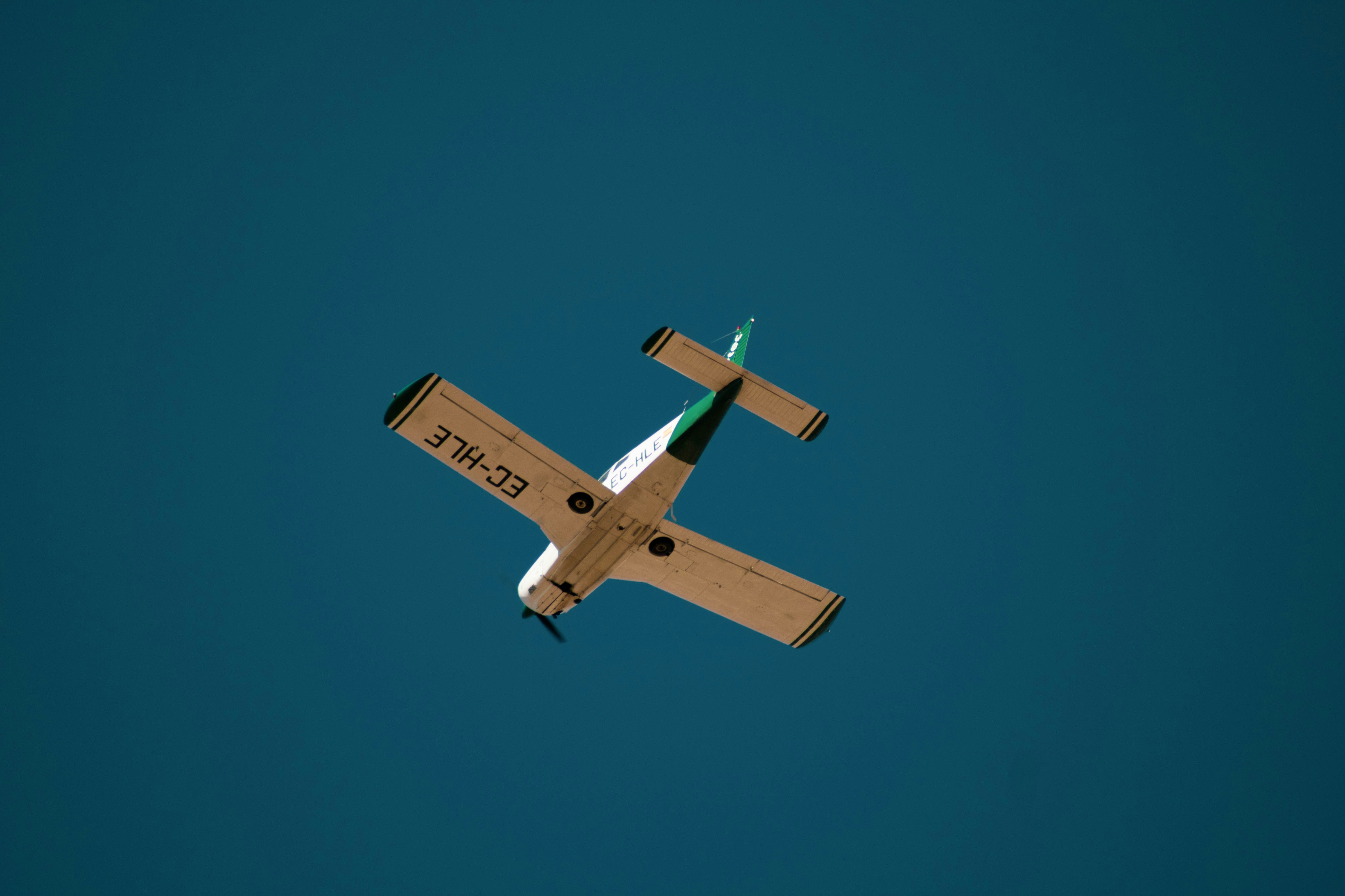 white and brown plane under blue sky during daytime