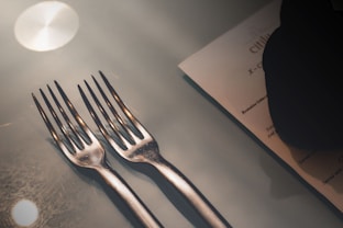 silver fork on white paper