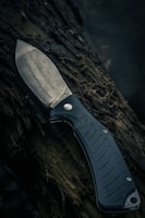 black and silver knife on brown wooden surface