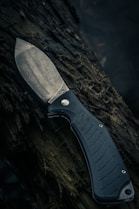 black and silver knife on brown wooden surface