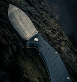 black and silver knife on brown wooden surface