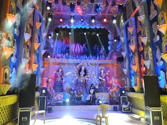 A vibrant stage set for the Didi Devika Rani Awards, adorned with elegant Indian cinema motifs and warm lighting.