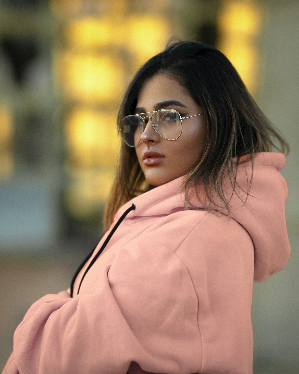 woman in pink hoodie wearing eyeglasses