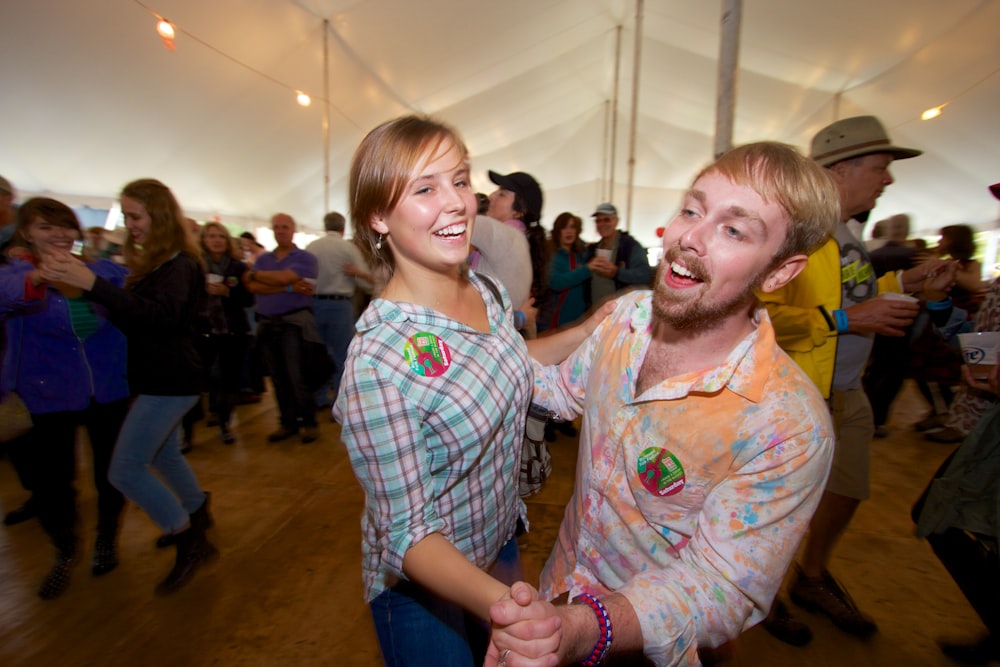 a man and a woman dancing in a tent