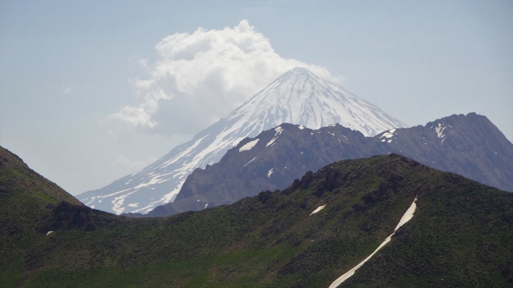 green and white mountain under white clouds during daytime