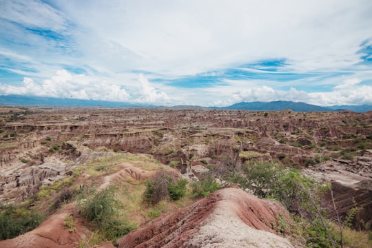 brown and green grass field under blue sky during daytime in Desierto de la Tatacoa Colombia