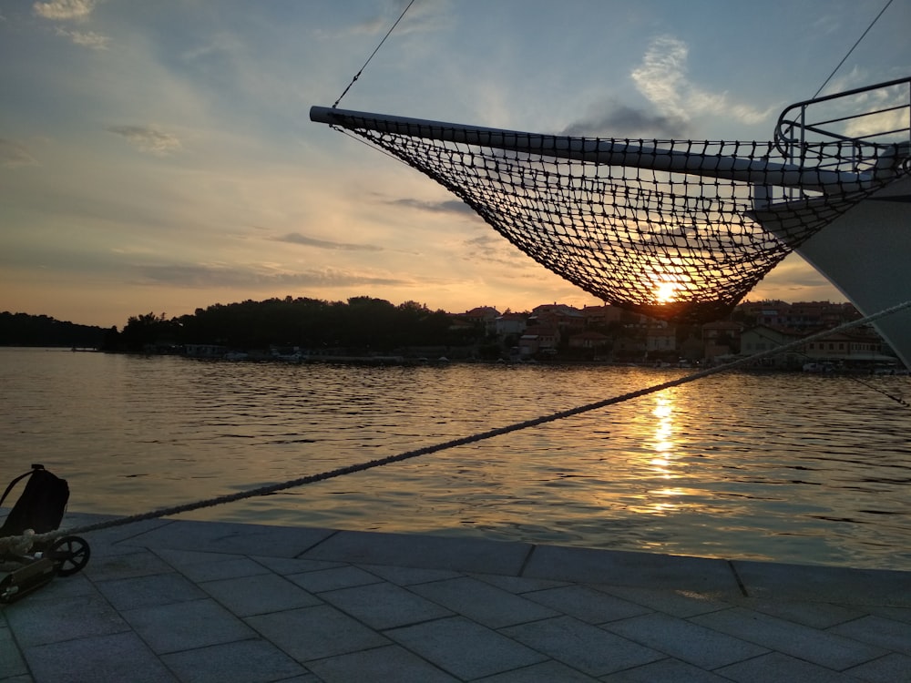 white and black boat on sea during sunset