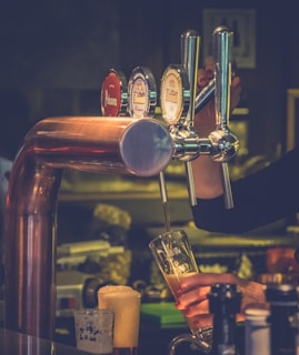 Close-up of a bartender expertly pouring a craft beer from a tap.
