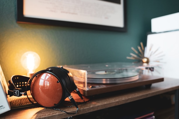 A cozy room with headphones resting on a vintage record player surrounded by music notes.
