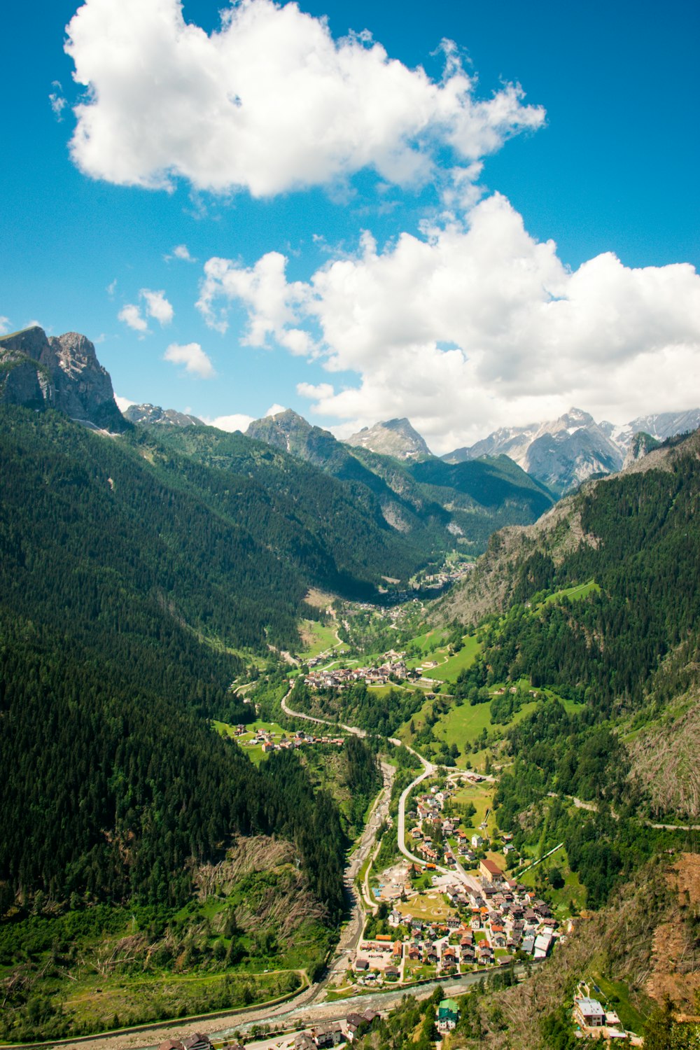 green mountains under blue sky and white clouds during daytime