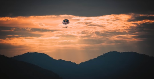 hot air balloon flying over the mountains during sunset in Penang Island Malaysia