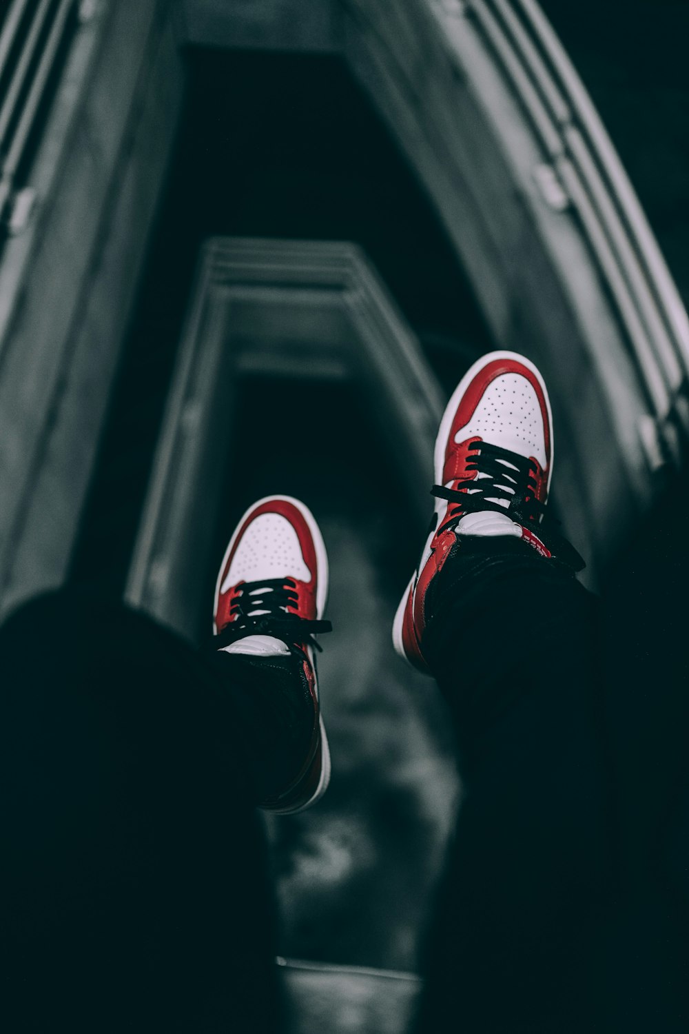 person wearing red and white sneakers