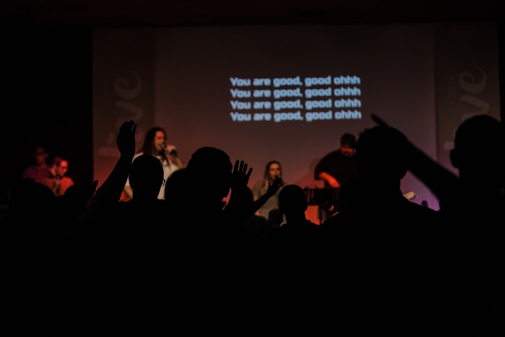 people standing on stage with lights