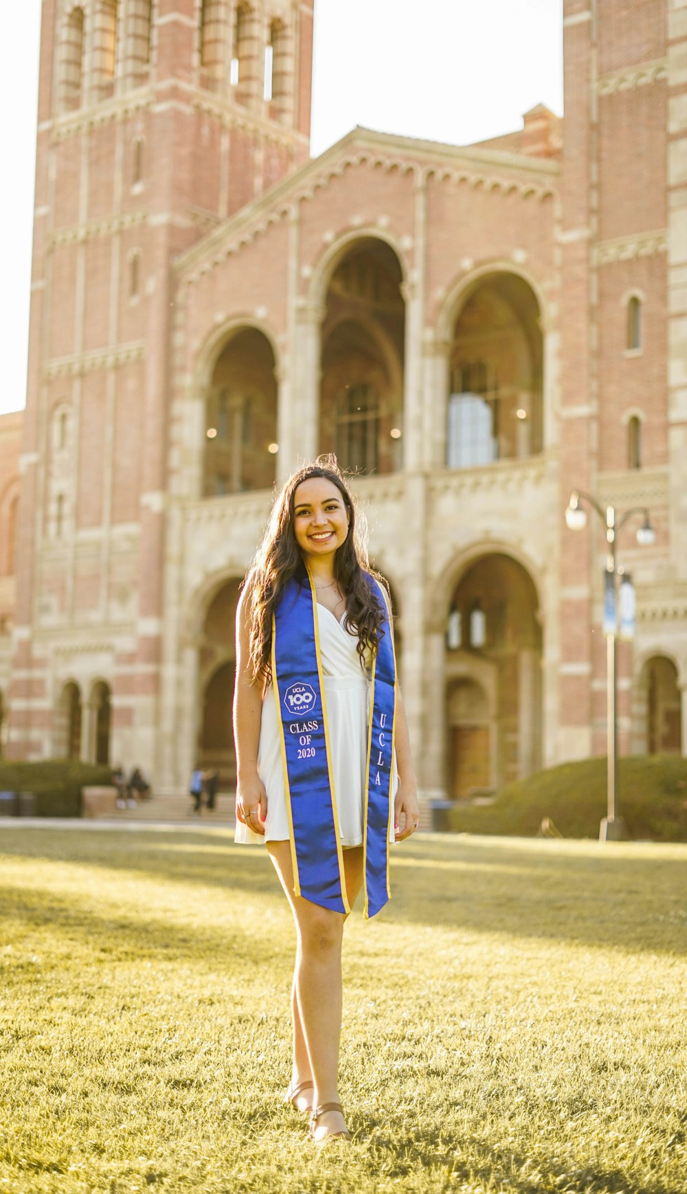 woman in blue and white long sleeve shirt standing on green grass field during daytime