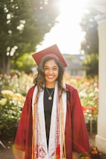 A warm outdoor portrait of a smiling high school senior in casual attire.
