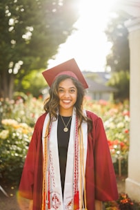A warm outdoor portrait of a smiling high school senior in casual attire.