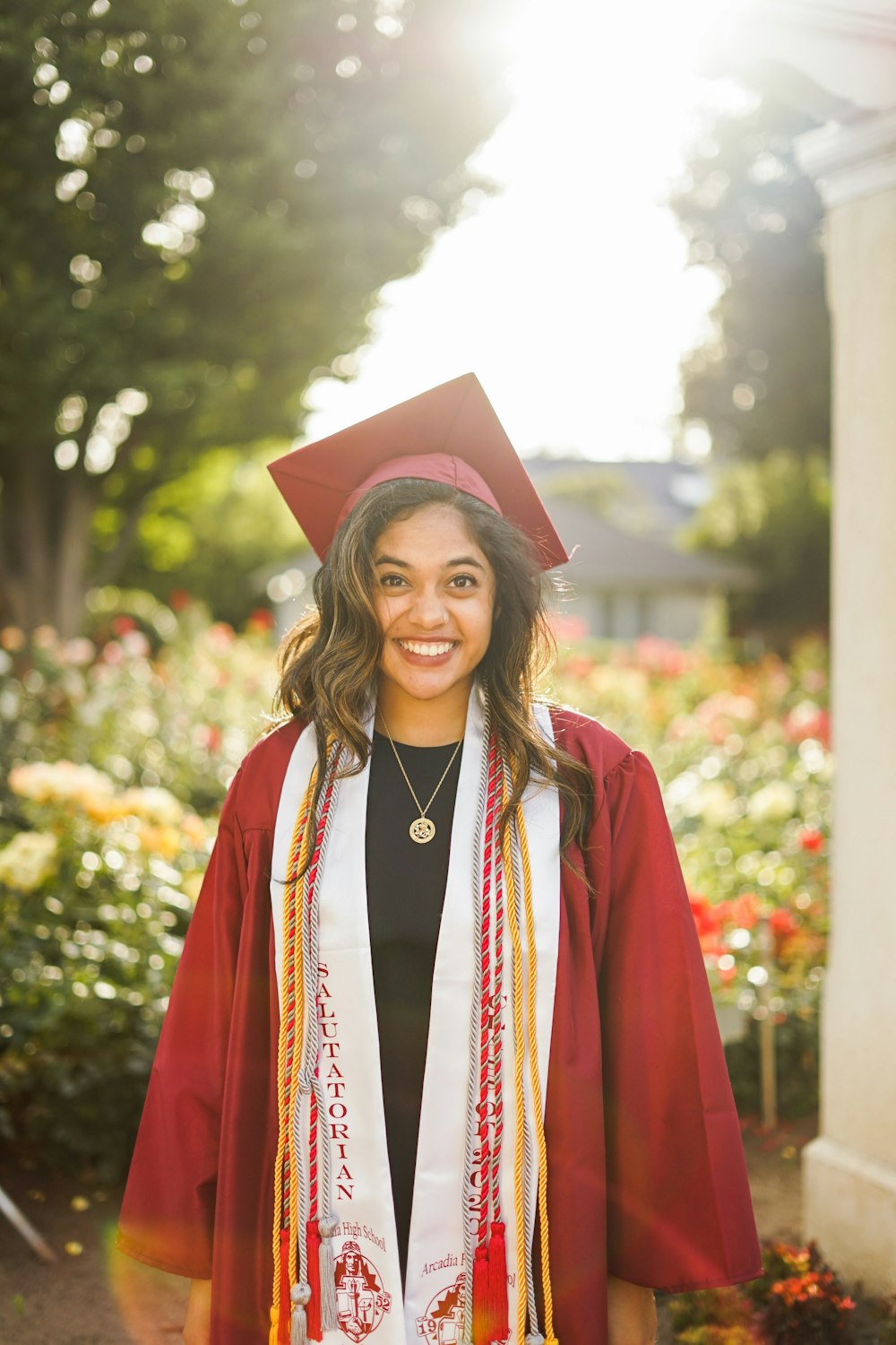 woman in red academic dress wearing red academic hat