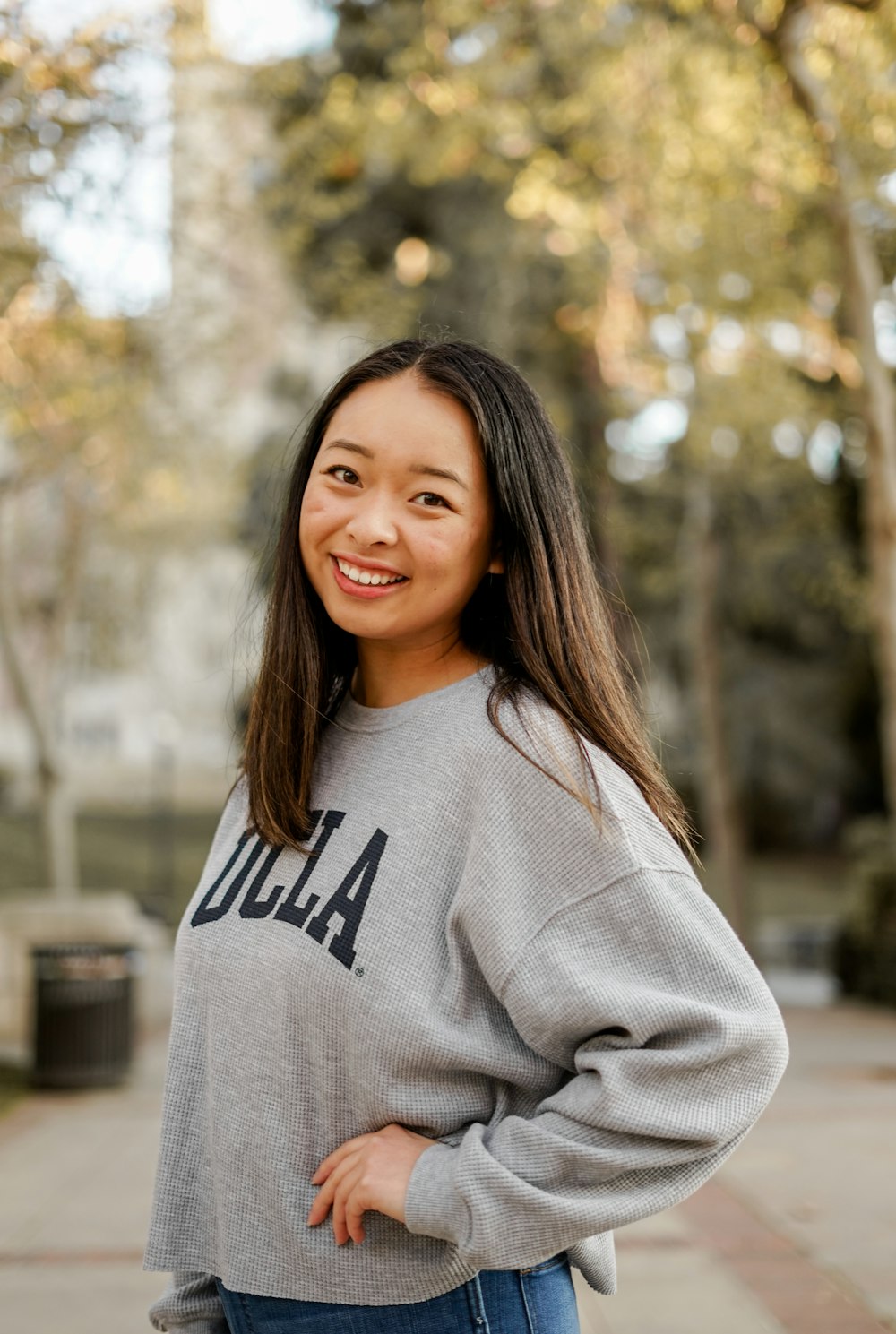 woman in gray and black crew neck sweater smiling