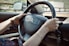person holding black honda steering wheel