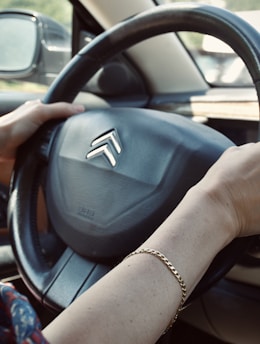 person holding black honda steering wheel