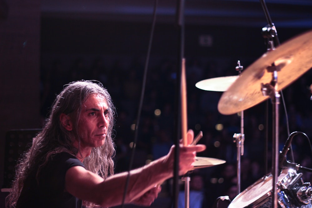 woman in black shirt playing drum