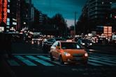 yellow taxi cab on pedestrian lane during night time