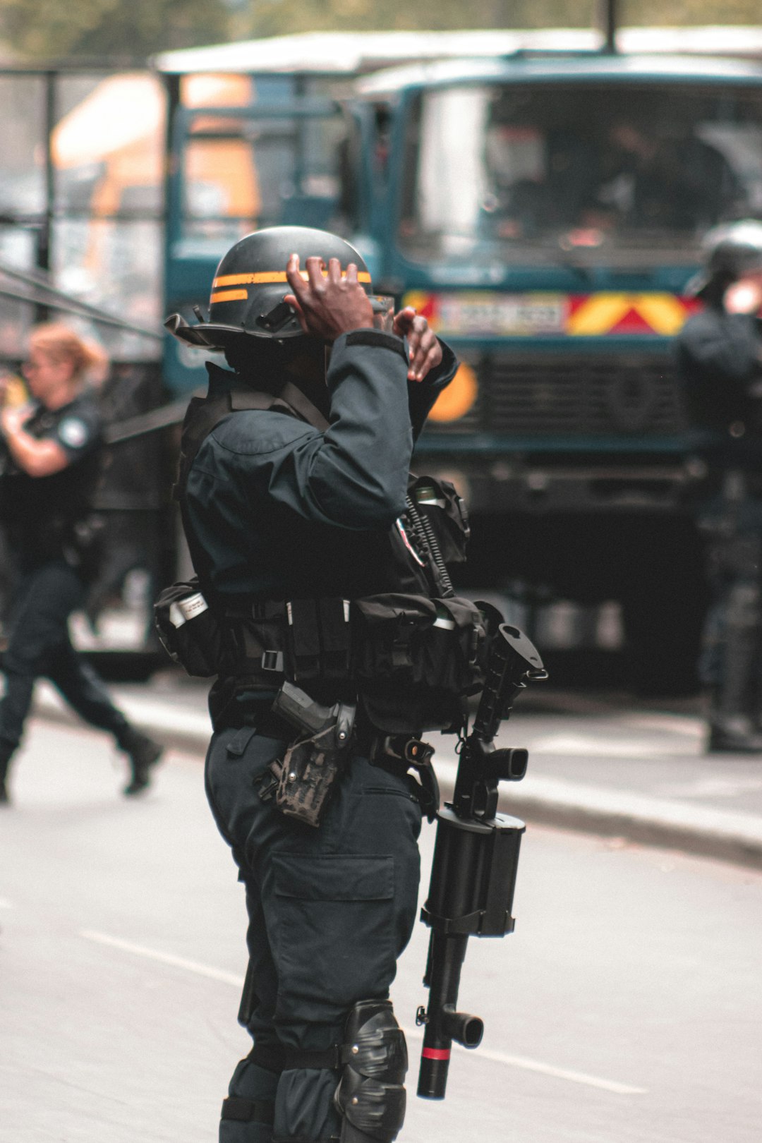 man in black jacket and helmet holding black dslr camera