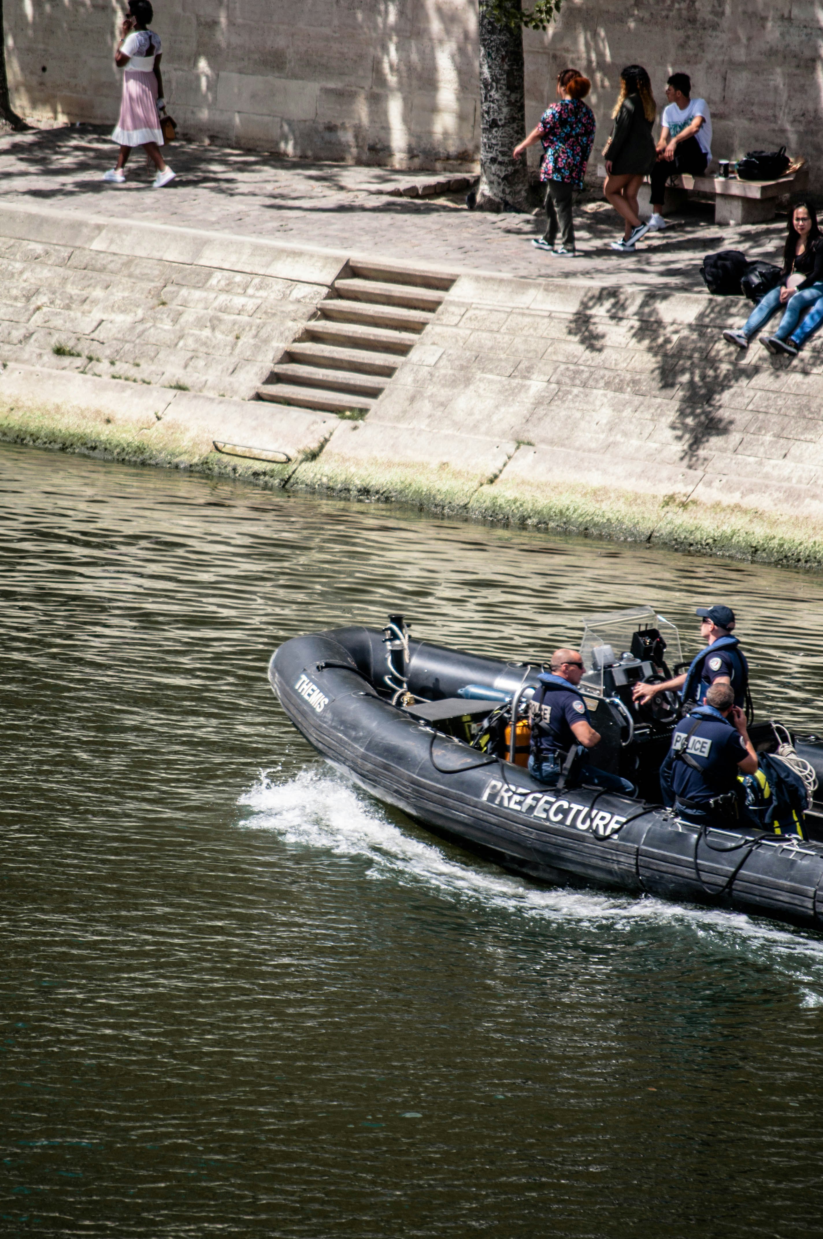 people riding on black inflatable boat on water during daytime