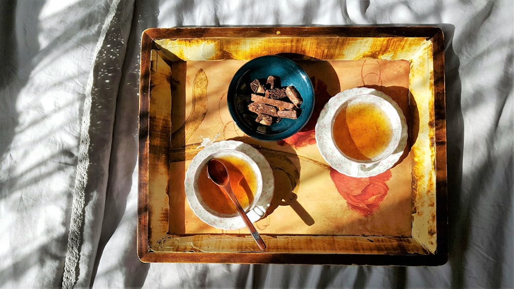 white ceramic bowl on brown wooden tray