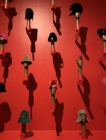 An elegant vintage hat perched on a mannequin head with soft lighting.