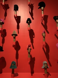 An elegant vintage hat perched on a mannequin head with soft lighting.